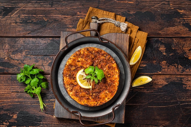 Traditioneel heerlijk Turks voedsel lahmacun met gehakt lamsvlees in stalen dienblad Houten achtergrond Bovenaanzicht