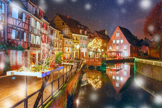 Traditionele Elzasser vakwerkhuizen in Petite Venise of klein Venetië oude stad van Colmar versierd en verlicht op besneeuwde kerstnacht Elzas Frankrijk