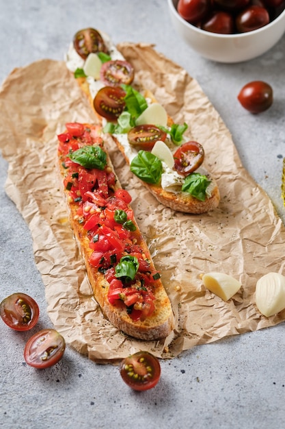 Traditionele italiaanse bruschetta met tomaat, oregano, olijfolie en basilicum. het proces van het bereiden van snacks.