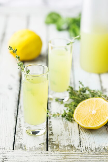 Traditionele Italiaanse citroenlikeur limoncello en verse citruscitroen. Alcoholische drank.