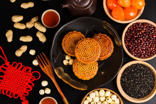 Traditionele mooncakes op lijst die met theekopje plaatst.