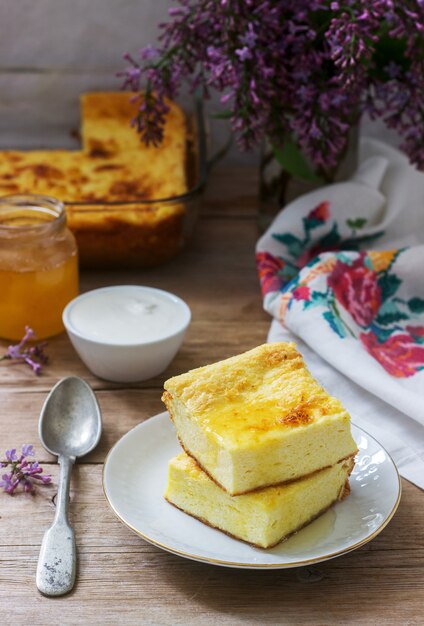 Traditionele Roemeense of Moldavische cottage cheese braadpan met maïsmeel, geserveerd met honing en zure room.