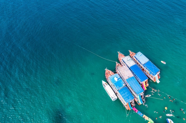 Traditionele veerboot verankerd en toeristisch snorkelen en genieten met koraalrif in tropische zee