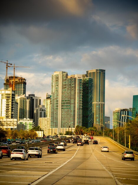 Traffic on city street by buildings against sky