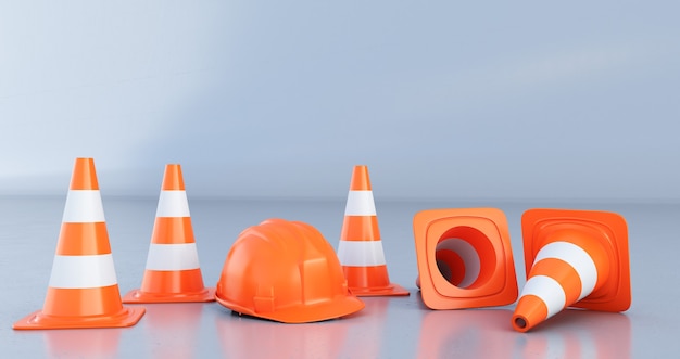 Traffic cones and orange helmet isolated on grey background