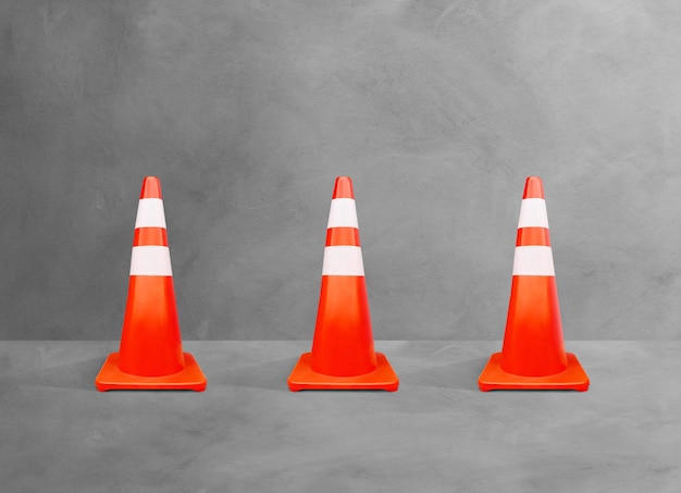 Traffic cones whiteorange poles isolated on cement floor