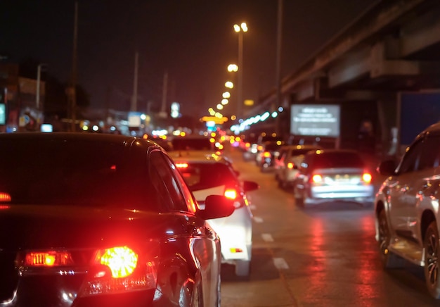 Traffic jams in city with row of cars on road at night