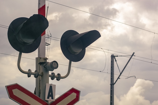 Traffic light at a railway crossing. The object of increased attention is at the intersection of the road and railways.