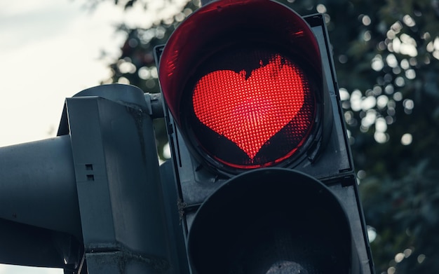 traffic light with red heart-shape in the city