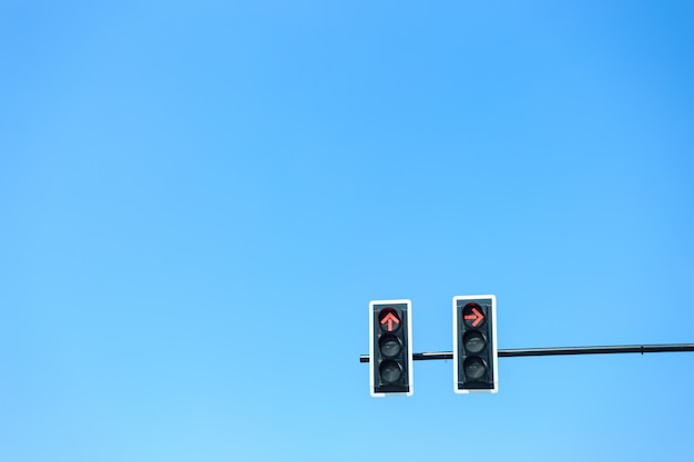 Traffic light with red light against the blue sky