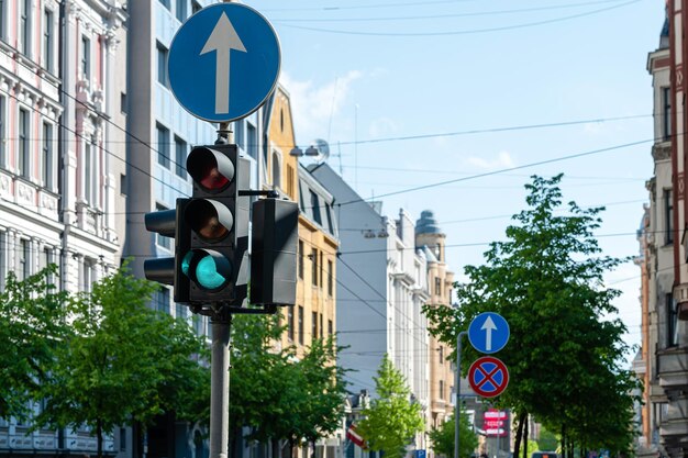 Traffic semaphore with green light on the background of defocused urban street