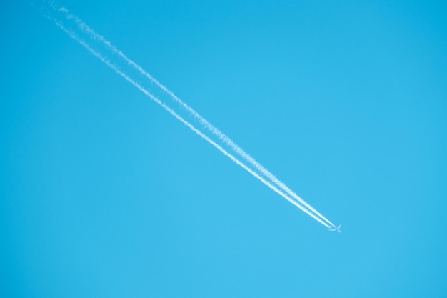 Trail of jet plane on blue sky