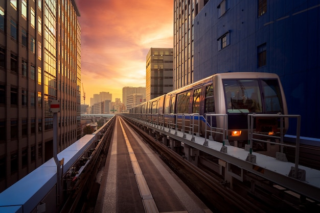 Train in city in Tokyo with sunset background