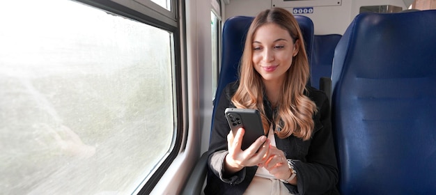 Train female passenger using mobile phone during travel commute Panoramic banner of people lifestyle commuting on autumn