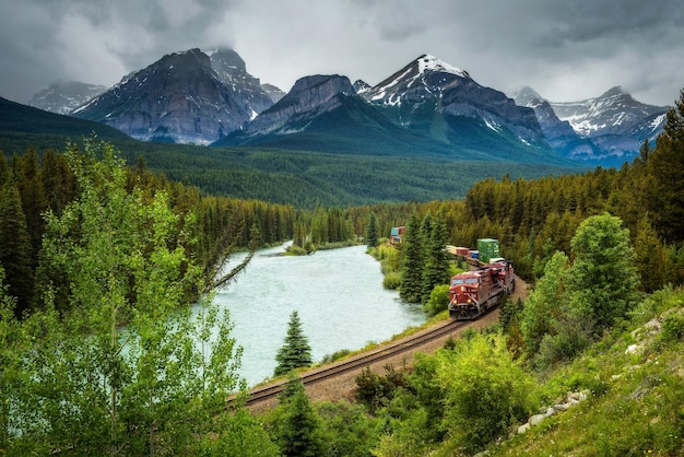 Train passing through Morant's Curve in bow valley Canada