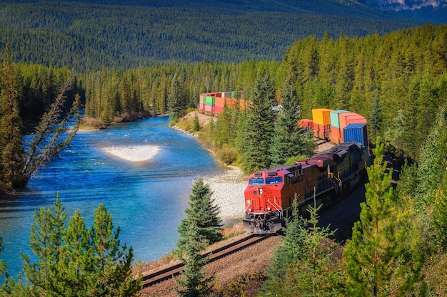 Train passing through Morant's Curve in bow valley Canada