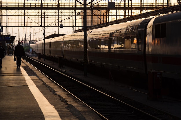 train at railroad station against sky