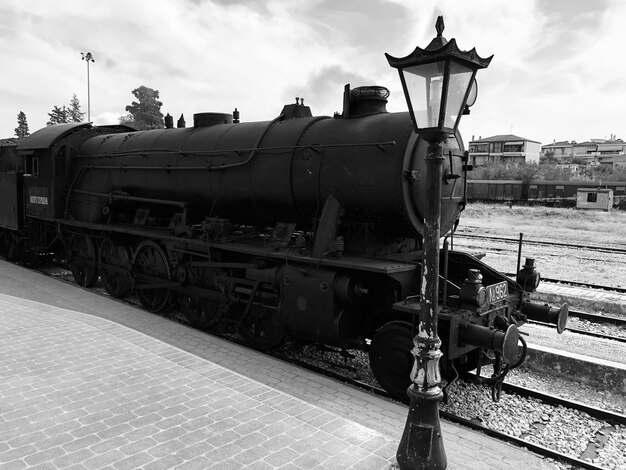 Train at railroad station against sky