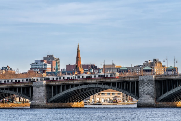 Train running over the longfellow bridge the charles river at the evening time, usa downtown skyline