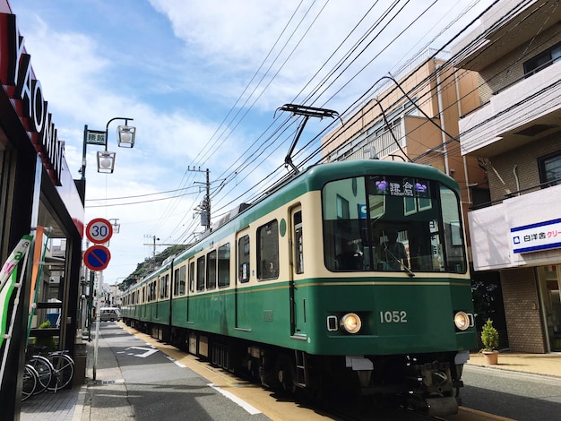 Train on street in city against sky