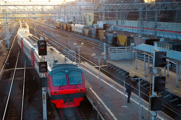 Train on the tracks in the setting sun at the railway station