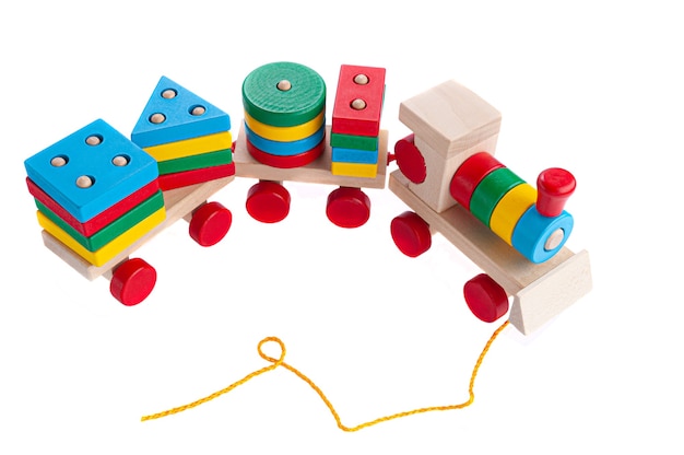 Train with carriages made of wood on a rope. Sorter game for children. Educational toy Montessori. White background. Close-up.