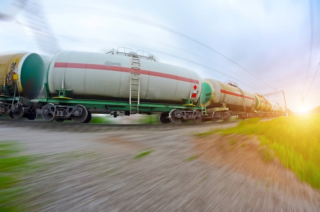 Train with oil tanks moving. Transportation of fuel on the railroad. Motion blur.