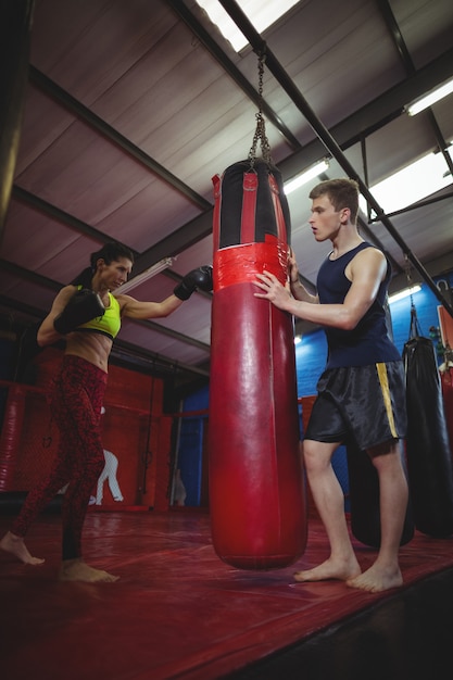 Trainer assisting a female boxer