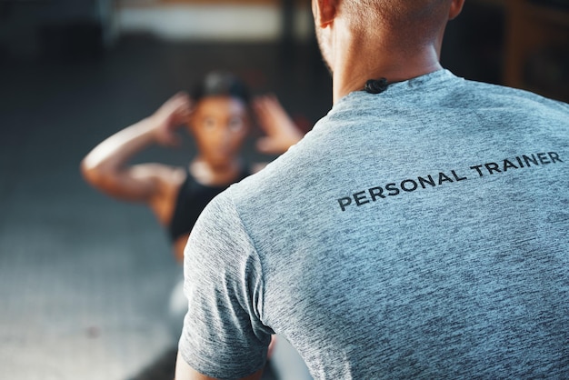 A trainer can make your exercise program a lot more effective closeup shot of a personal trainer assisting a client in a gym