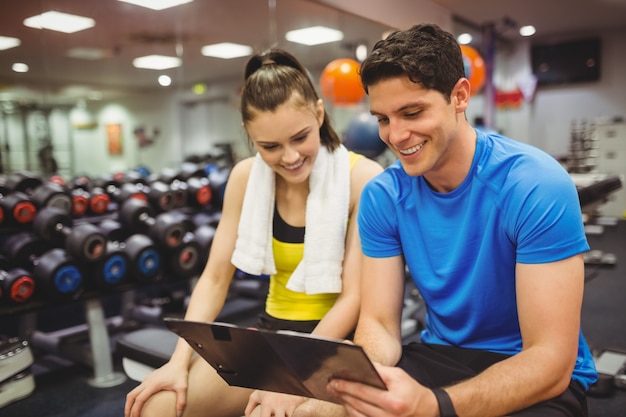 Trainer and client discussing her progress