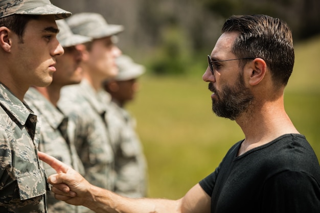 Trainer giving training to military soldier