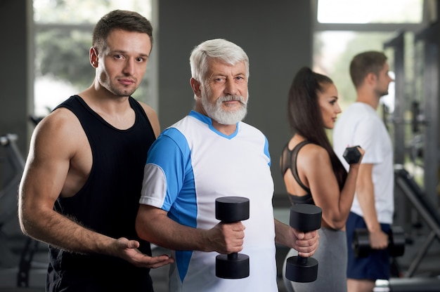 trainer helping his clients become healty and fit.