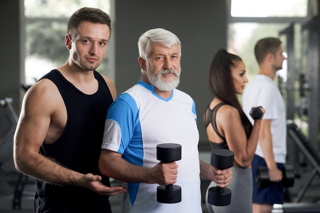 Trainer helping his clients become healty and fit.