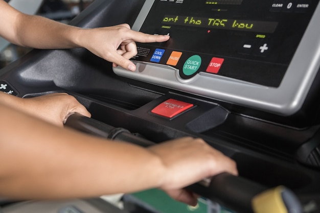 Trainer helping woman at the gym