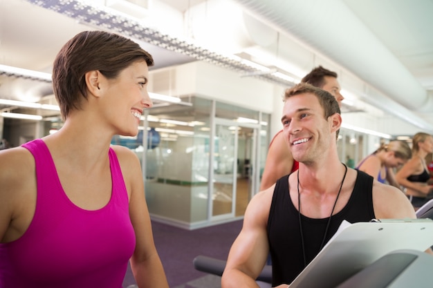 Trainer talking to his client on the treadmill