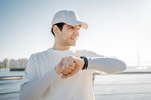 A trainer using smart fitness watch that measures pulse blood pressure male sports runner training