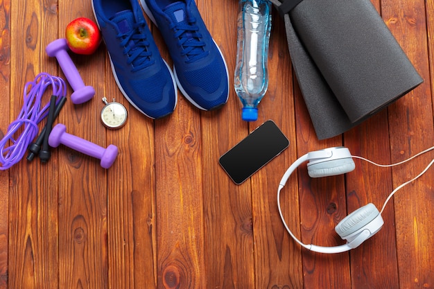 Trainers with mobile phone on wooden table