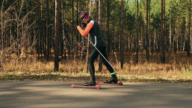 Training an athlete on the roller skaters biathlon ride on the\
roller skis with ski poles