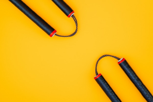 Training nunchaku isolated on a orange surface