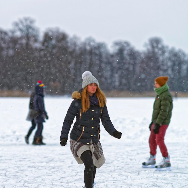 Trakai, lithuania - january 17, 2016: young woman ice skating
on winter rink. skating involves any activity which consists of
traveling on ice using skates