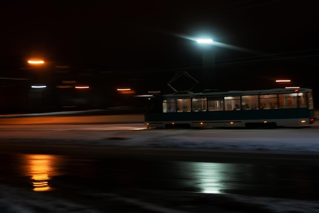 Tram rides in the dark in the snow