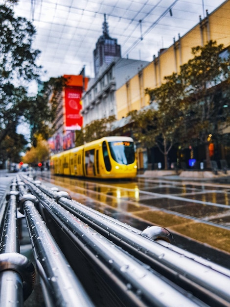 Photo tram on wet street in city