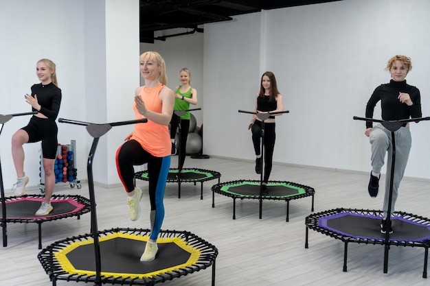 Trampoline for fitness girls are engaged in jumping trampoline\
woman fitness jump girl in the