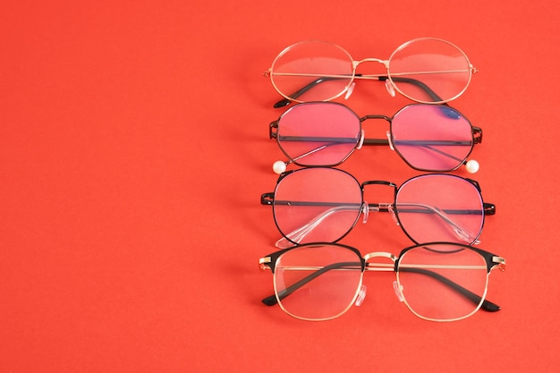 Trandy eye glasses on bright red background