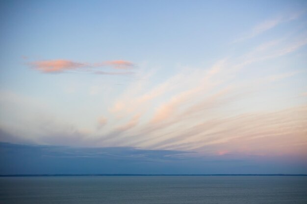 Tranquil nature scenery with long clouds covering blue sky