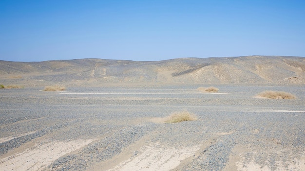 Tranquil white sand desert with clear blue sky Scenery in Tibet