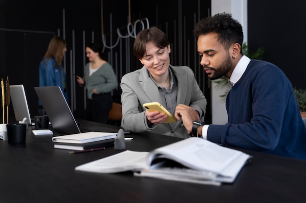 Trans person working at office with colleagues