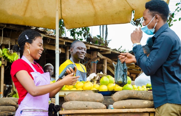 Transaction in a market place while a customer wears a face mask to prevent himself for the outbreak in the society .