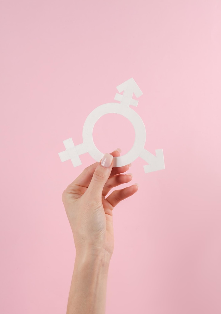 Photo transgender gender symbol in female hand on pink background