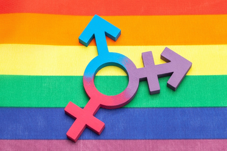 Photo transgender symbol and gender symbol of man and woman against the background of the rainbow flag of the lgbt pride.